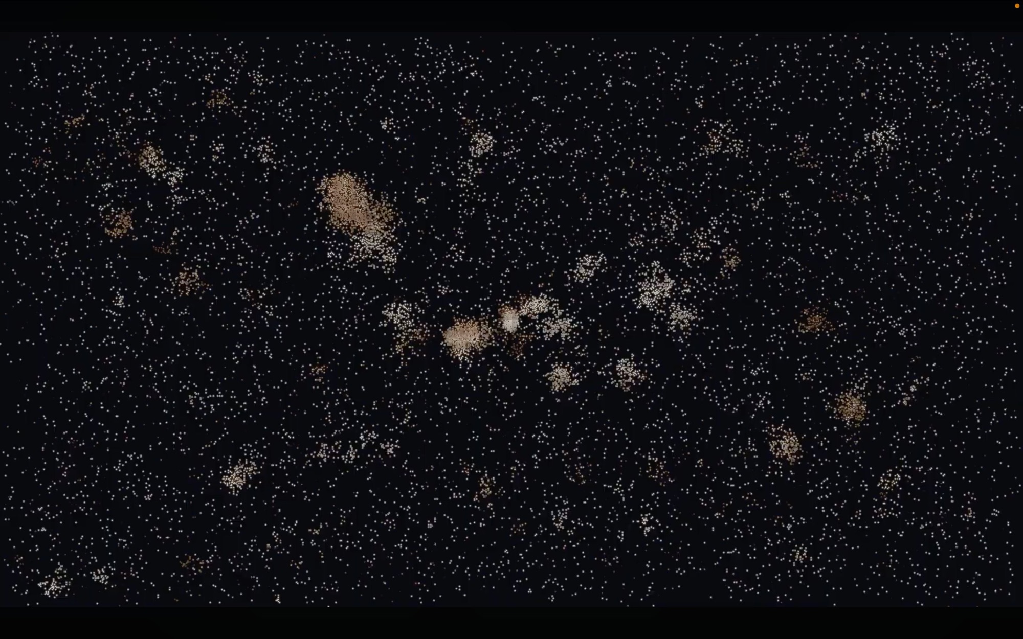 Still from the simulation: points of light drifting and merging into warm colour clusters on black